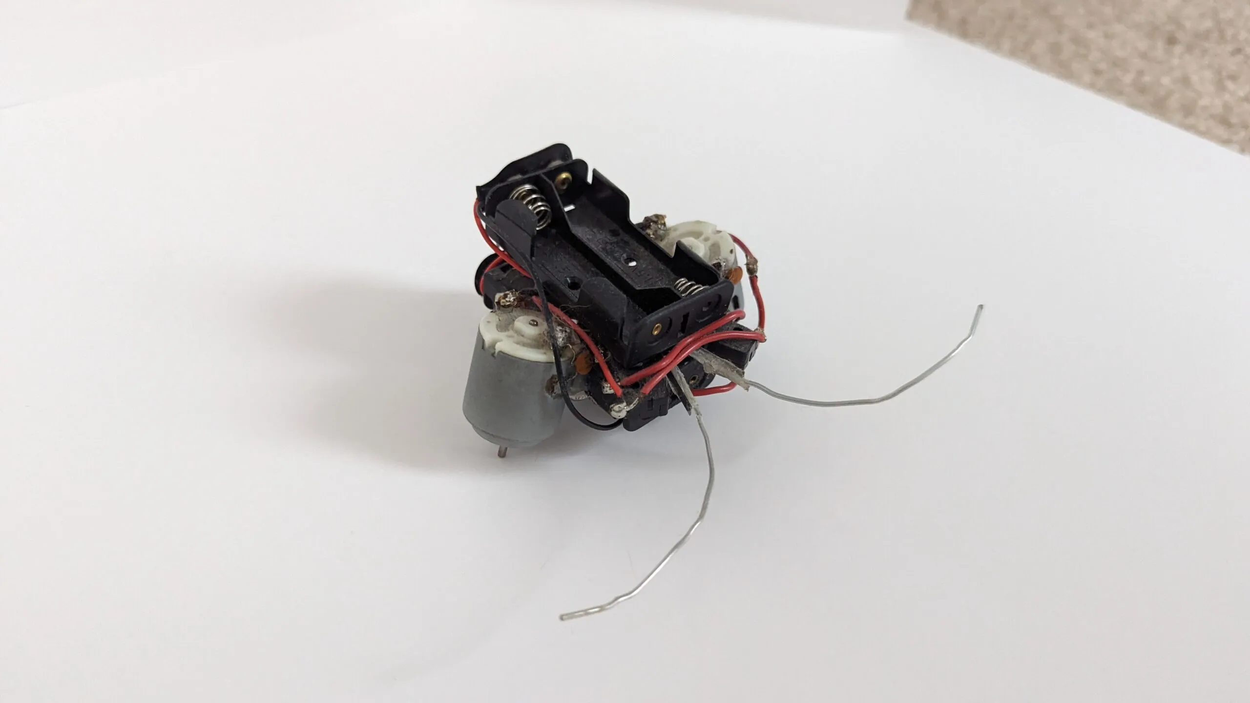 Rear view of a Beetle showing the empty AA battery holder that doubles as its chassis