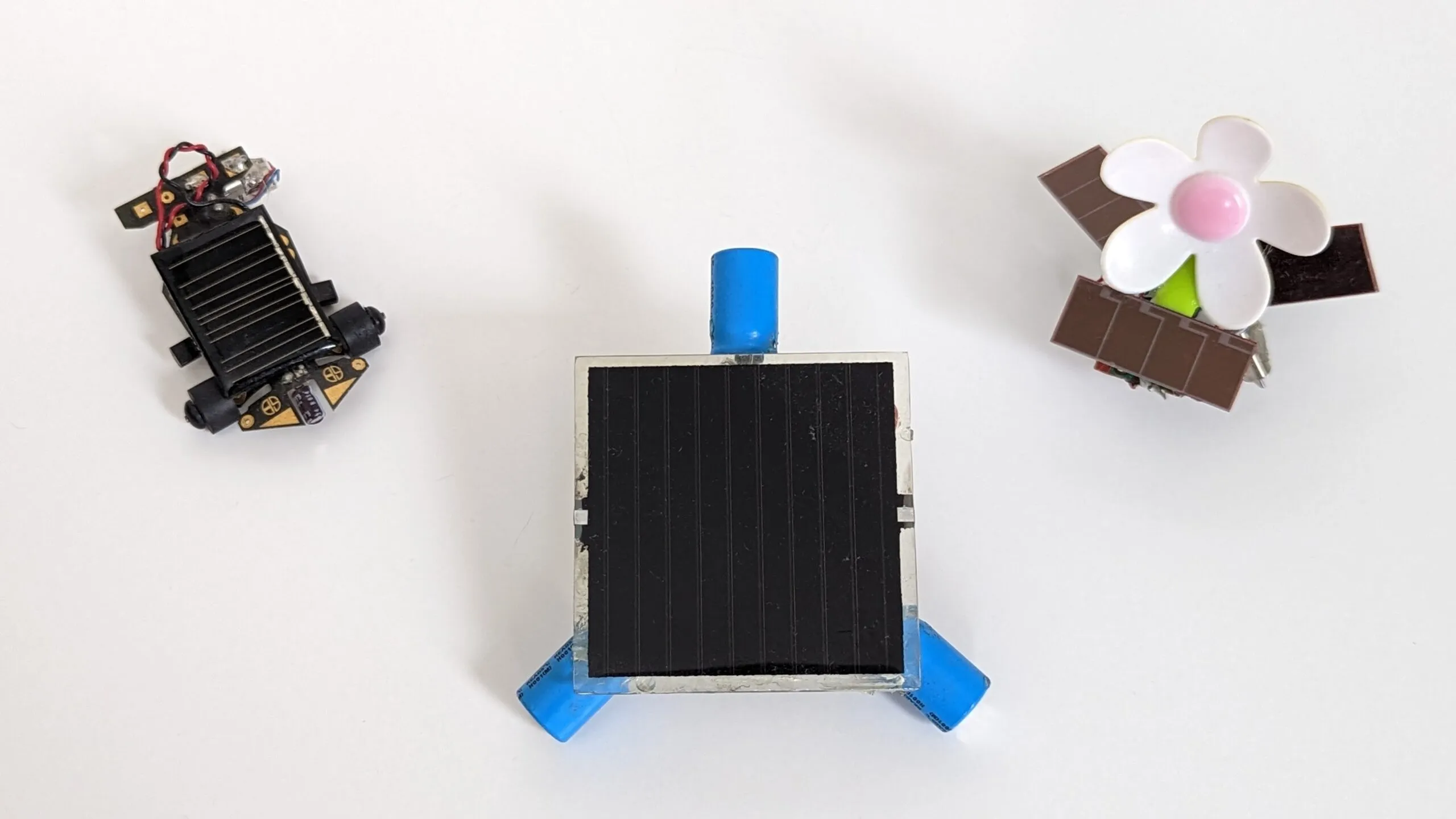 The three solar BEAM robots together: Solar Roller, Symet on its capacitor feet, and SymFlower
