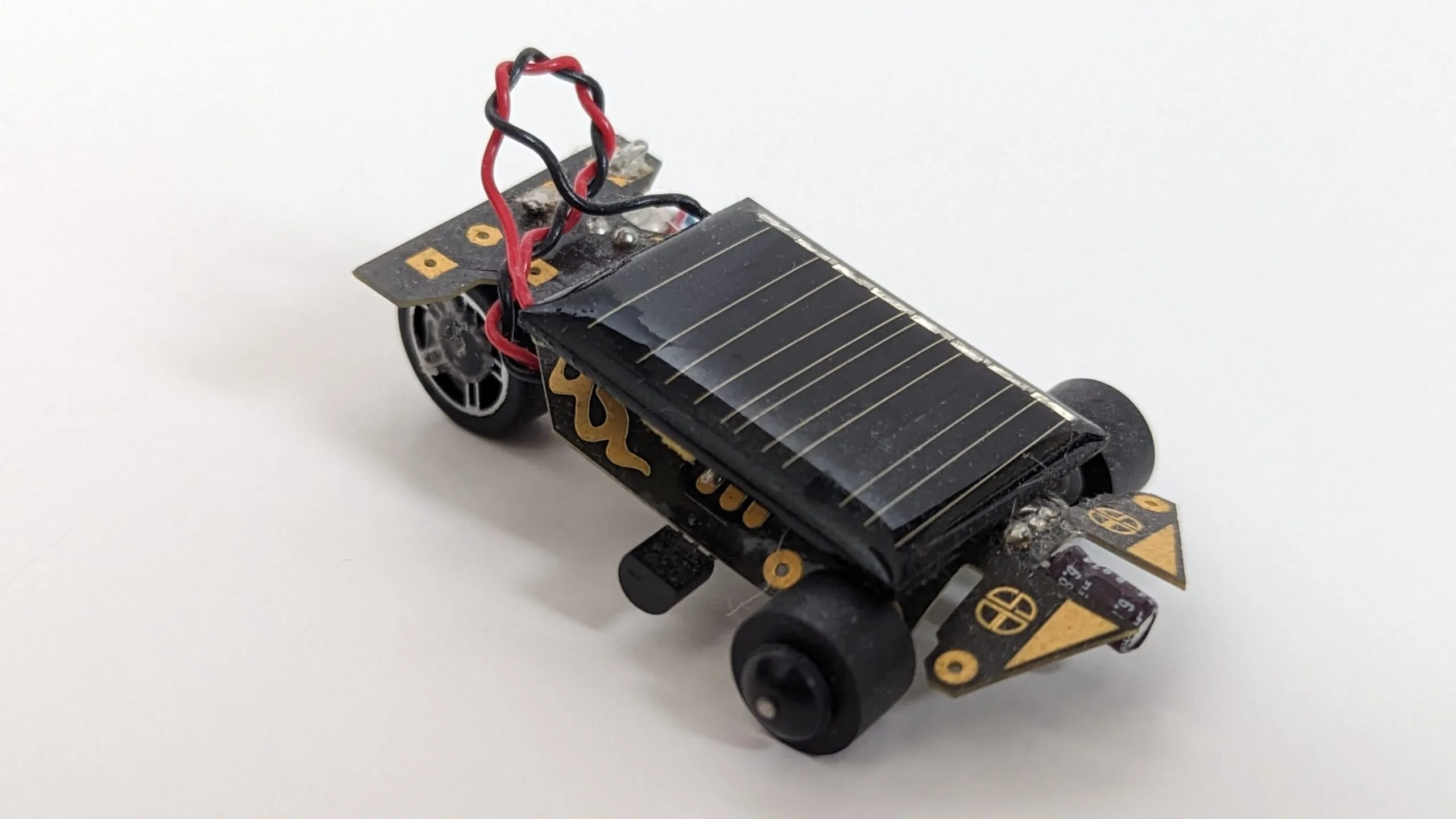 Three-quarter view of the Solar Roller showing its mismatched scavenged wheels