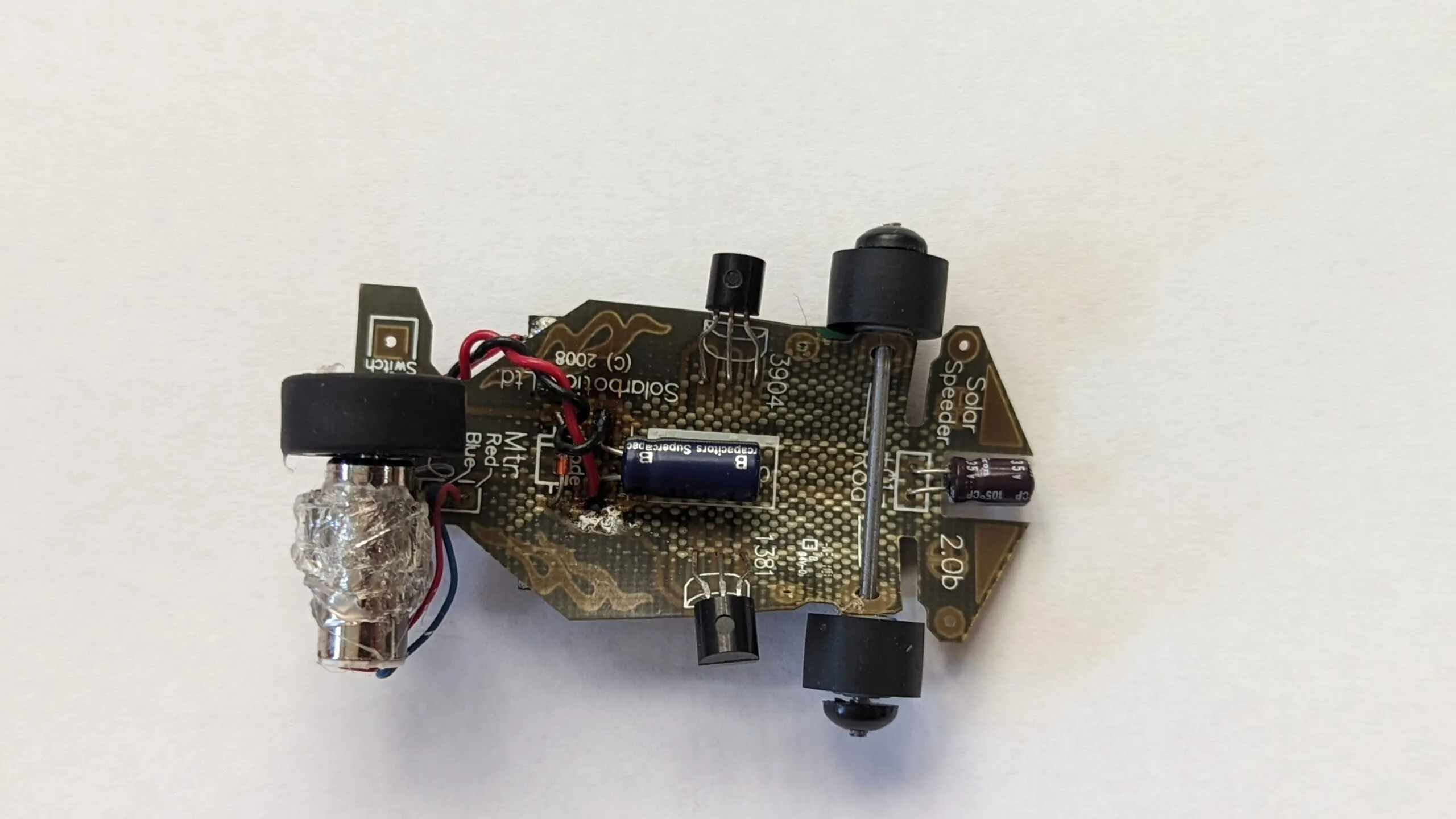 Underside of the Solar Roller: the Solarbotics Solar Speeder 2.0b board, supercap and driver transistors on show