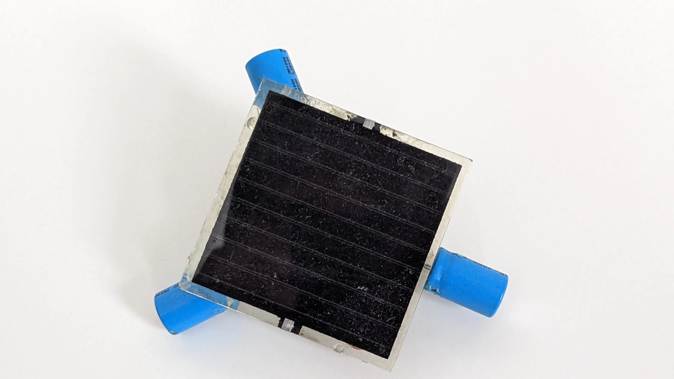 Close-up of the Symet's dusty solar cell, capacitor feet at the corners