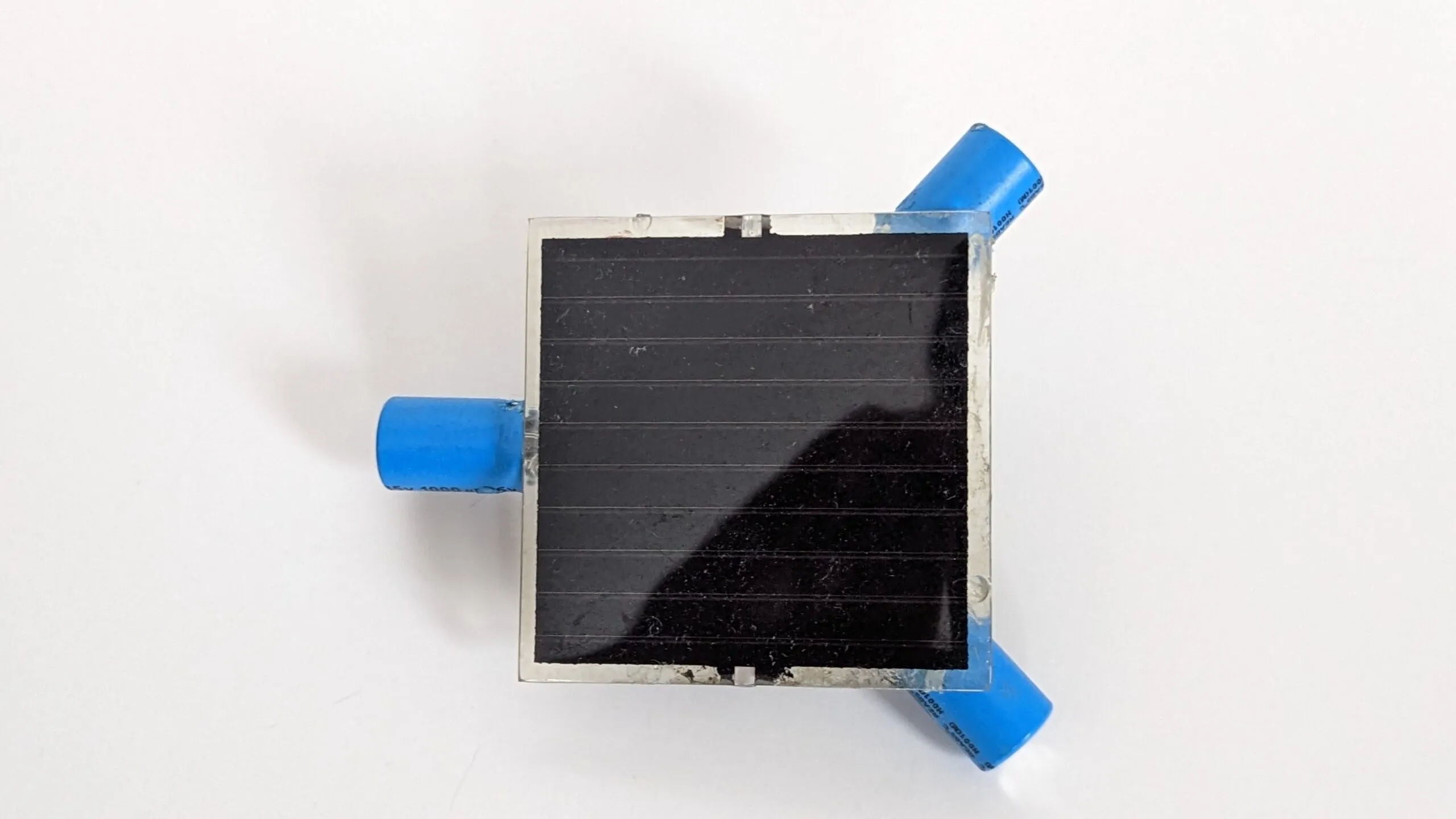 Top-down view of the Symet's solar cell with the three capacitor feet at its corners