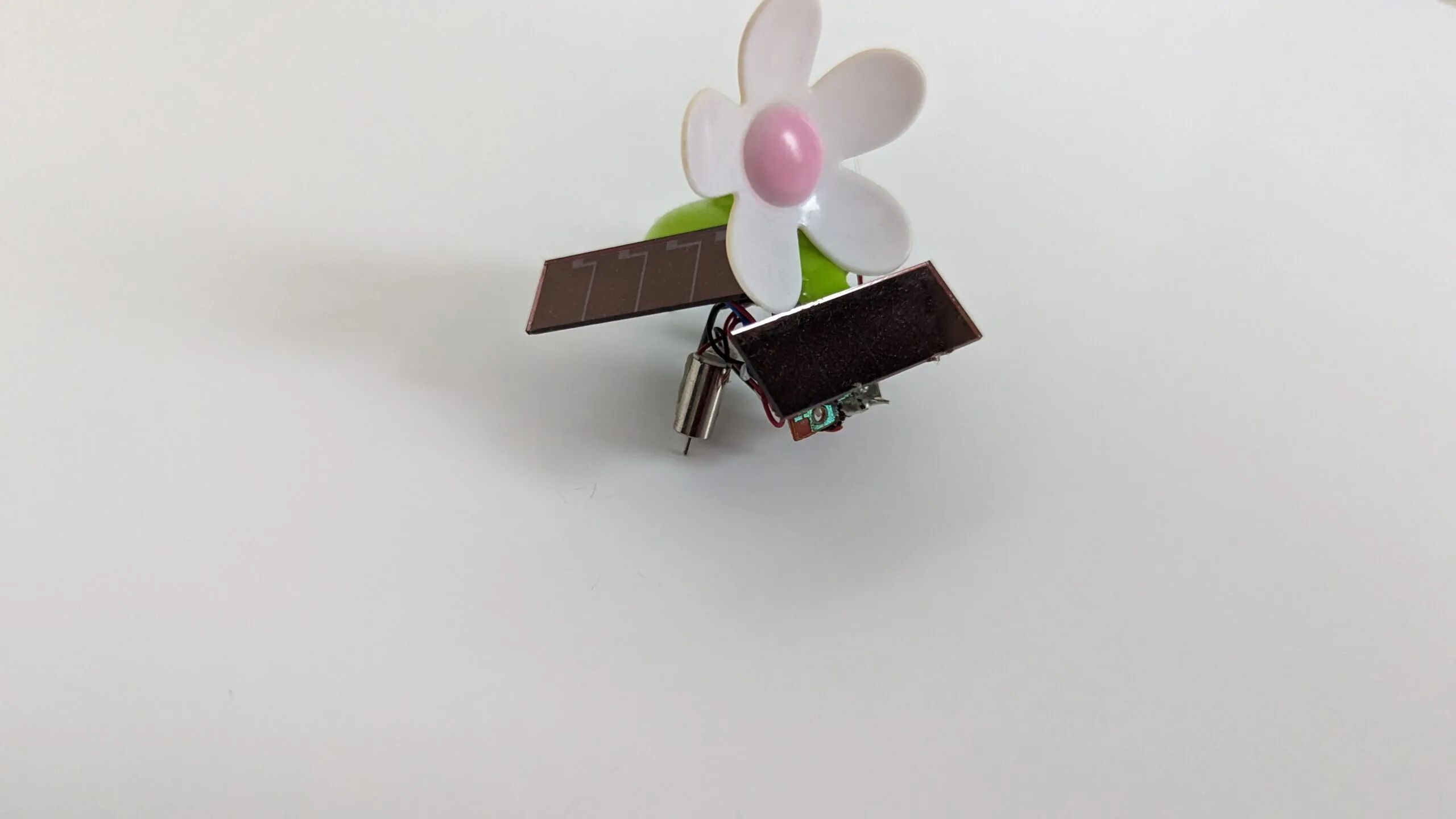 SymFlower v2 with its solar wings staggered fore and aft, a pager motor peeking underneath