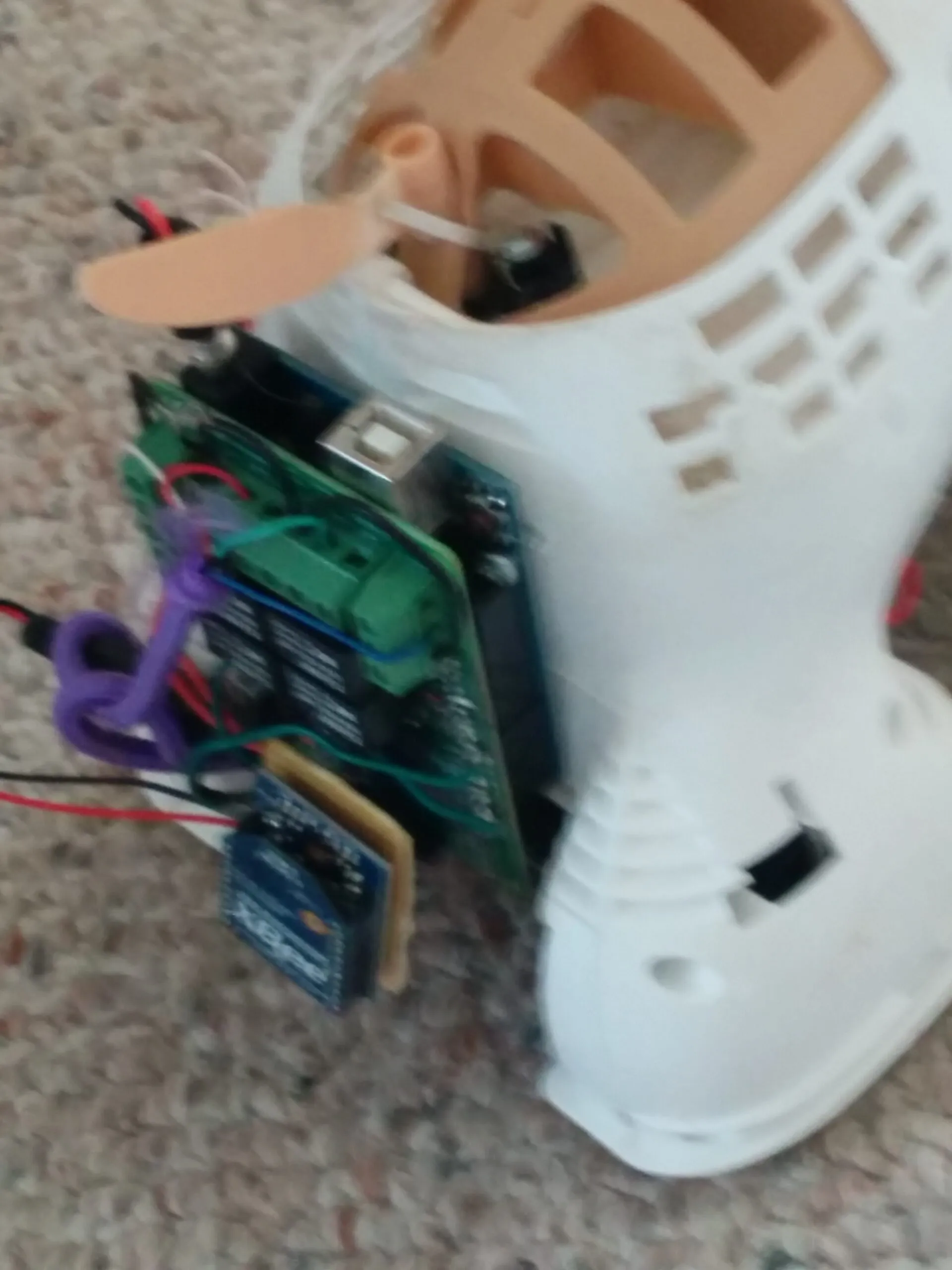 The 2014 electronics package: Arduino with the relay shield's green terminal blocks and the XBee breakout dangling off it, hanging out of Bubbles' opened shell