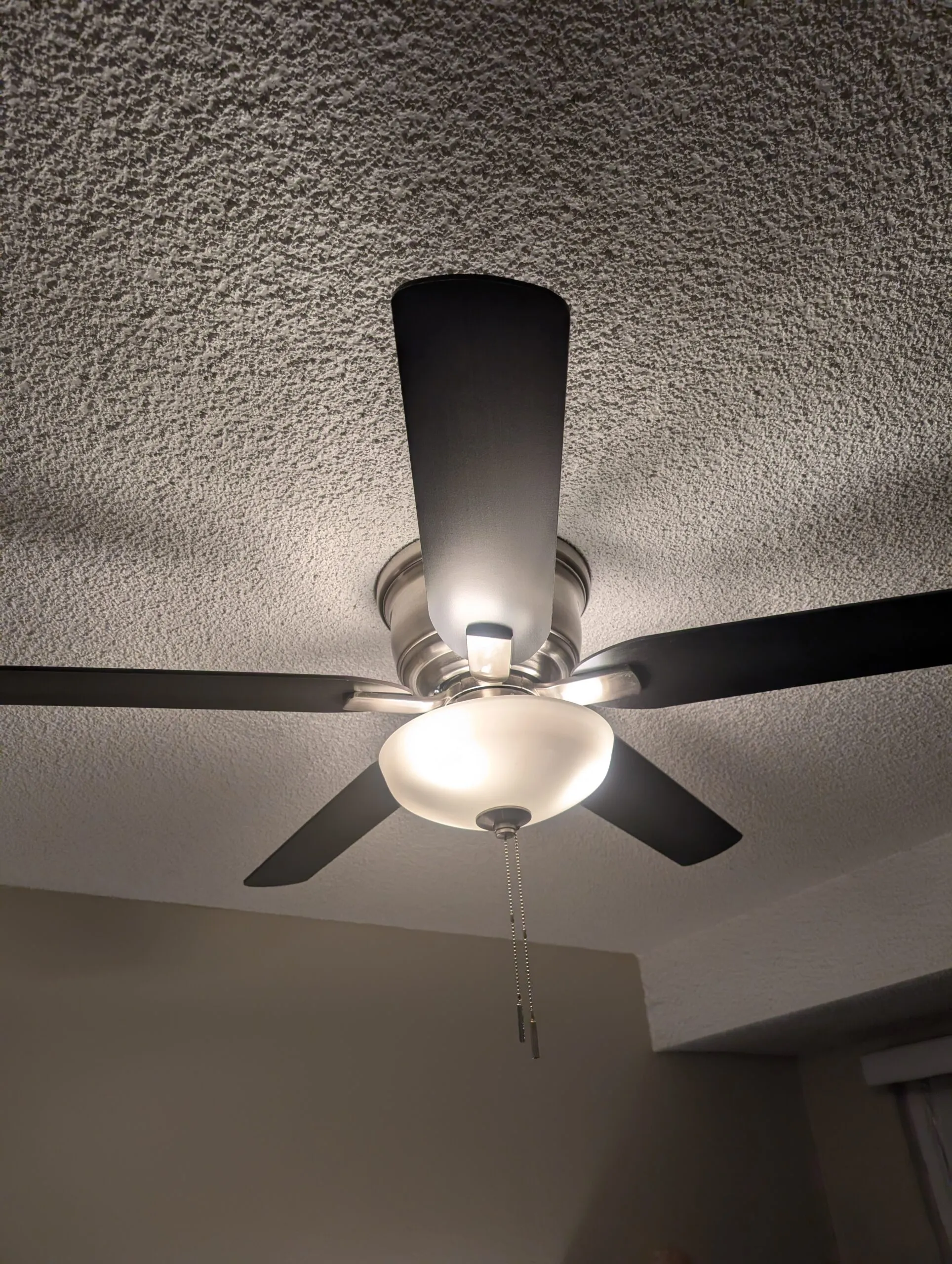 The bedroom ceiling fan, still pull-chain operated