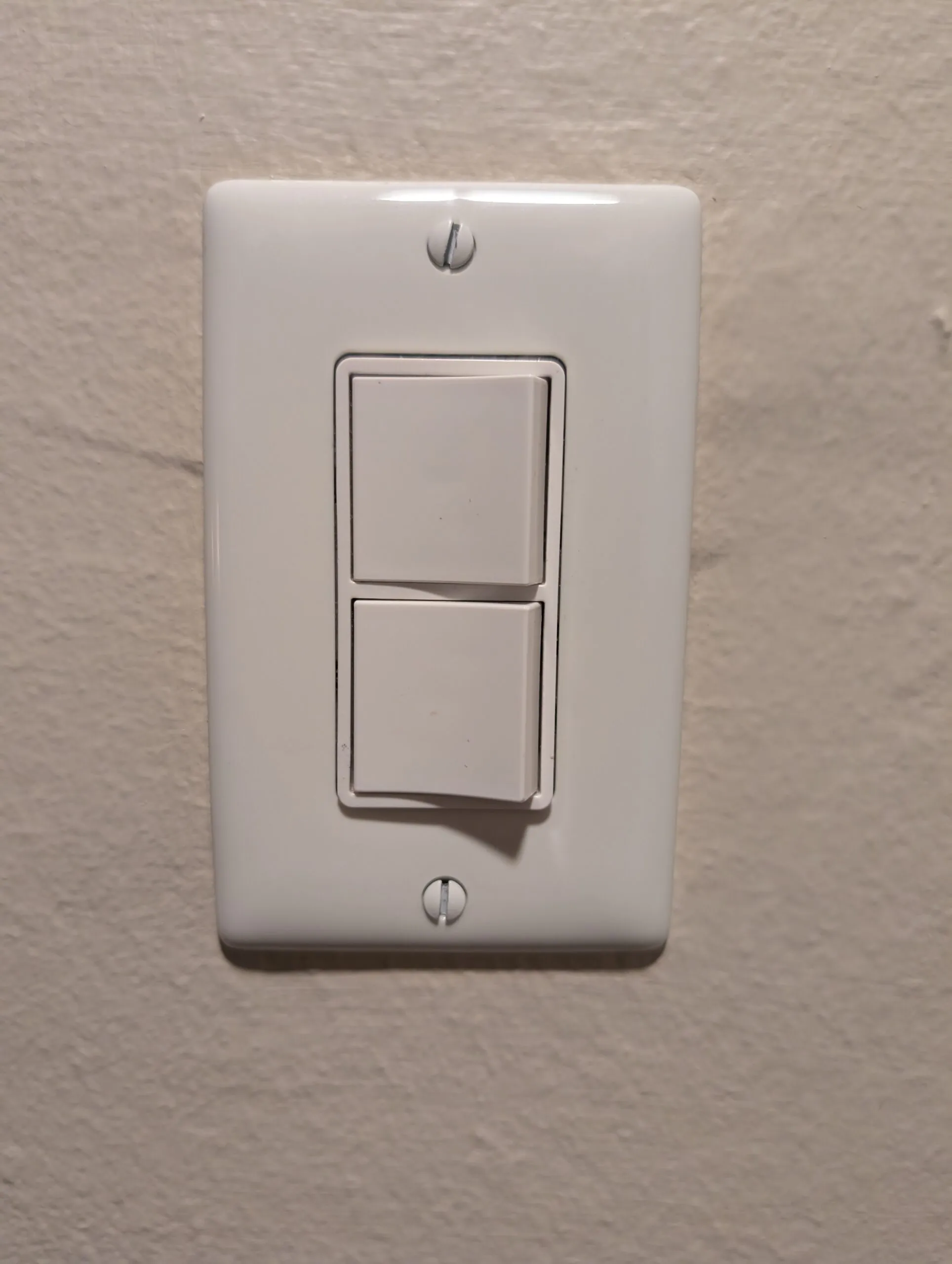 A stacked double rocker switch in a single wall plate