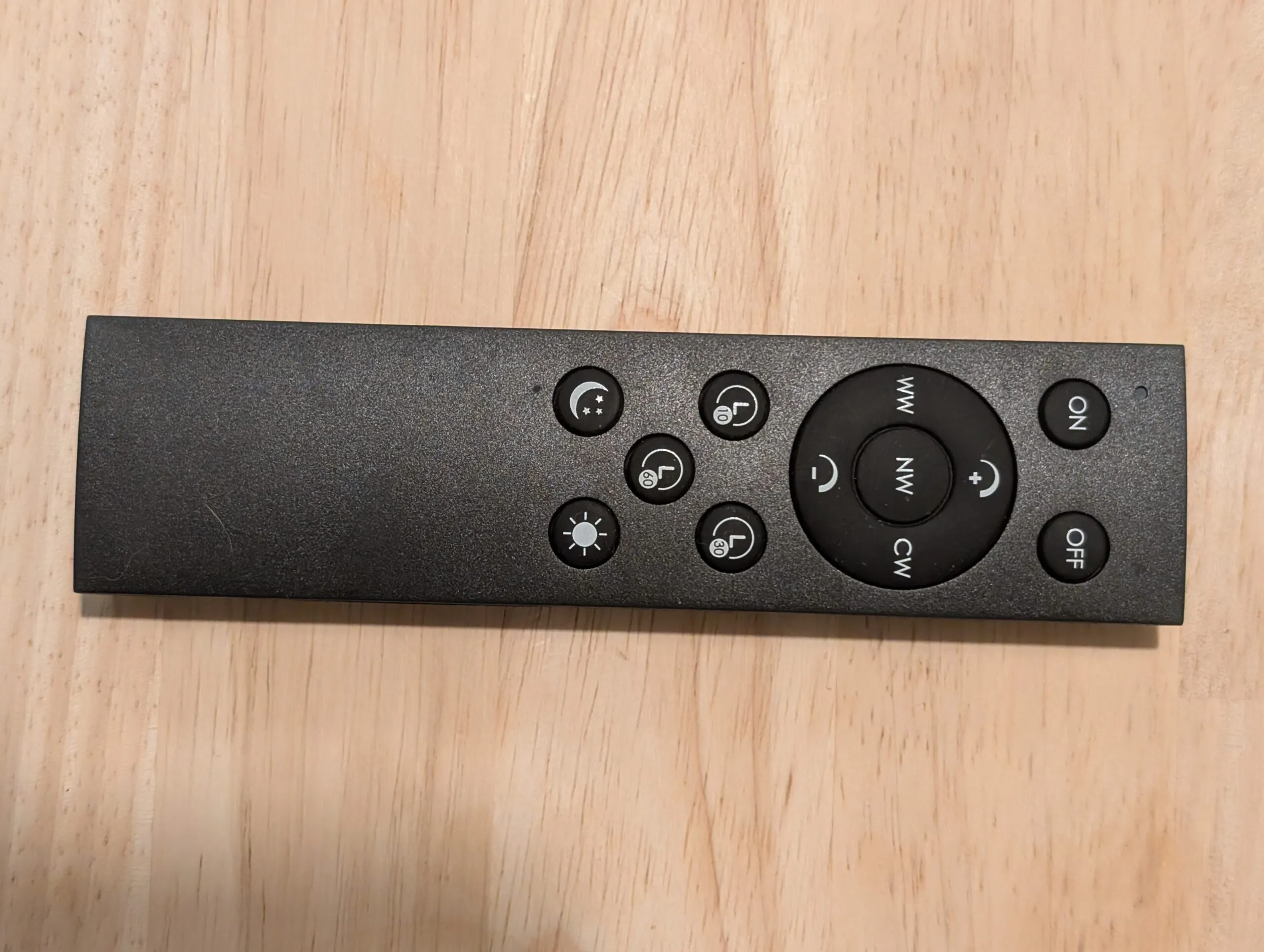 The lamp's remote: warm / neutral / cool white ring with dim and brighten, 10 / 30 / 60 minute timers, night mode, and ON and OFF