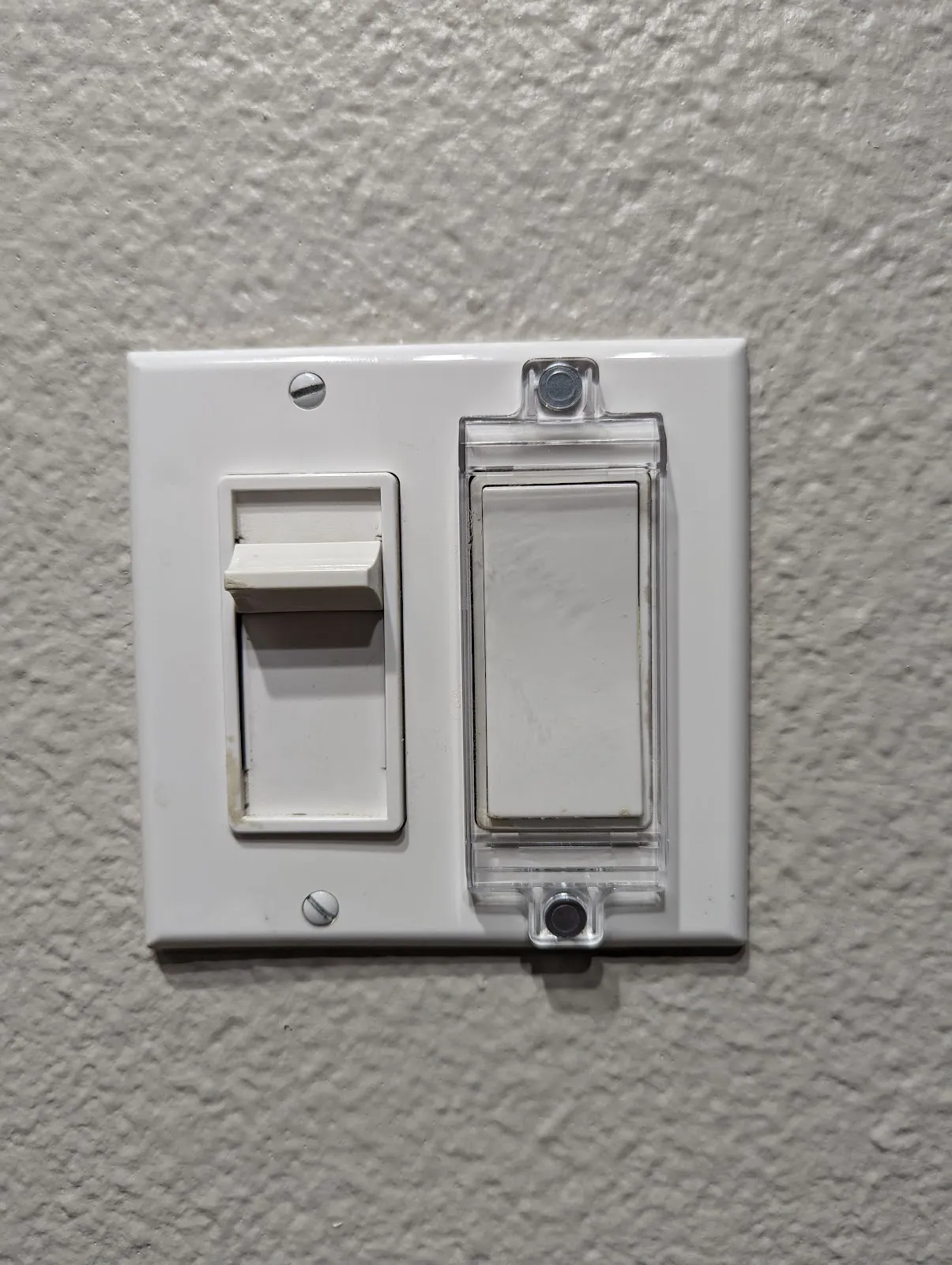 The stubborn slide dimmer beside its covered companion rocker, still without a good smart retrofit