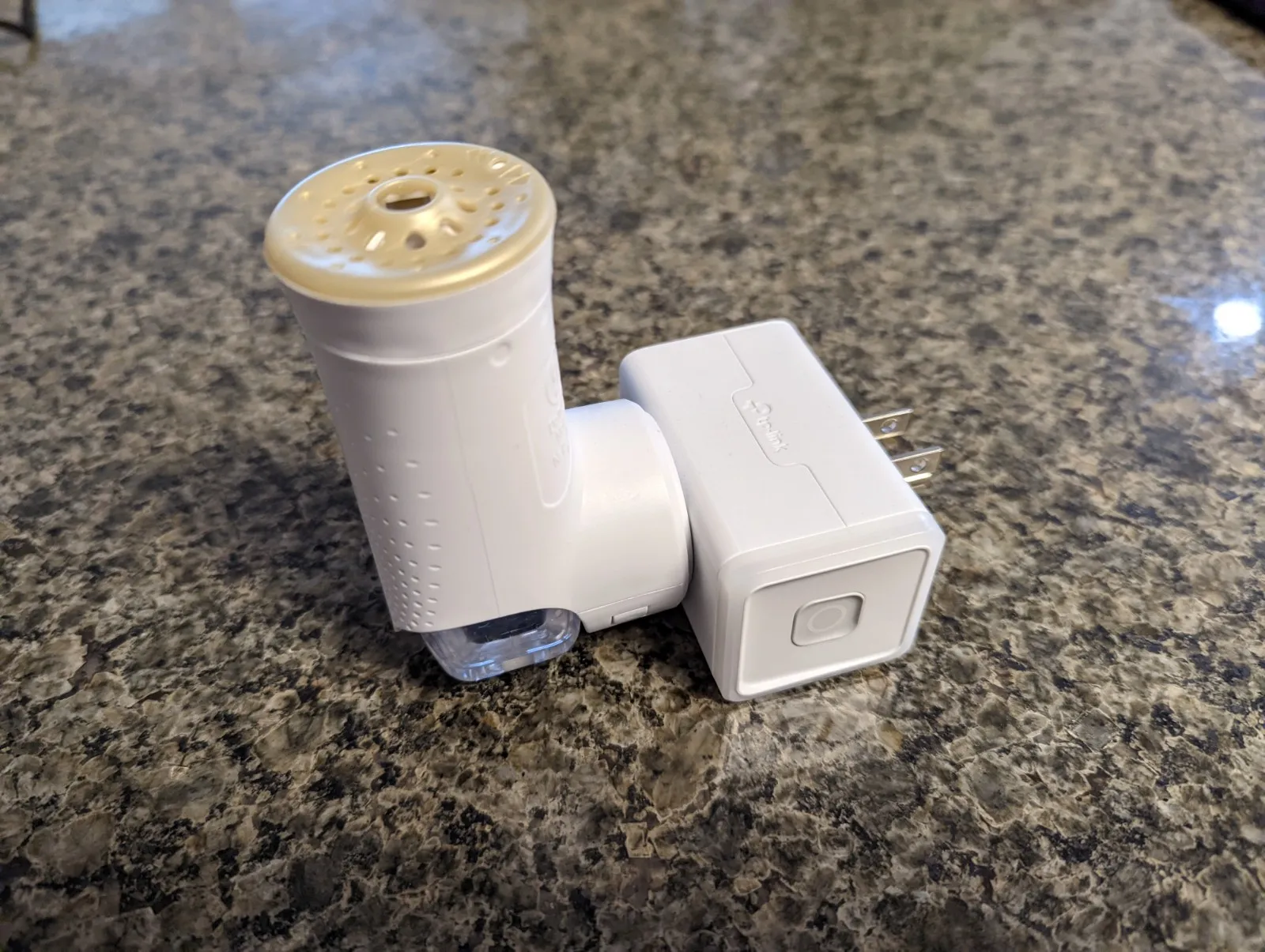 The Glade plug-in air freshener and the Kasa smart plug that switches it