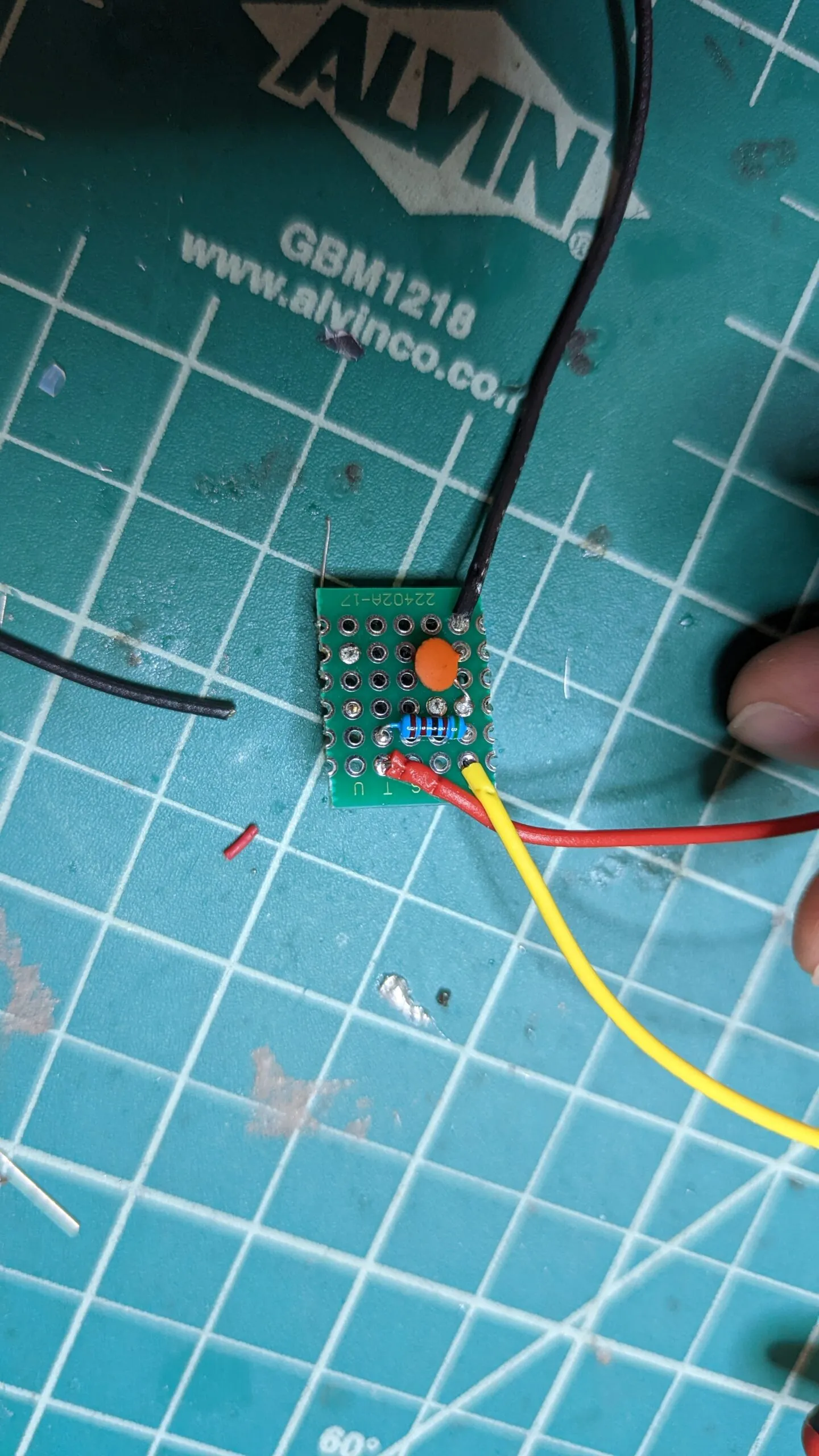 The back of the reset button board: a pull-up resistor and a small ceramic capacitor for debounce, leads soldered out