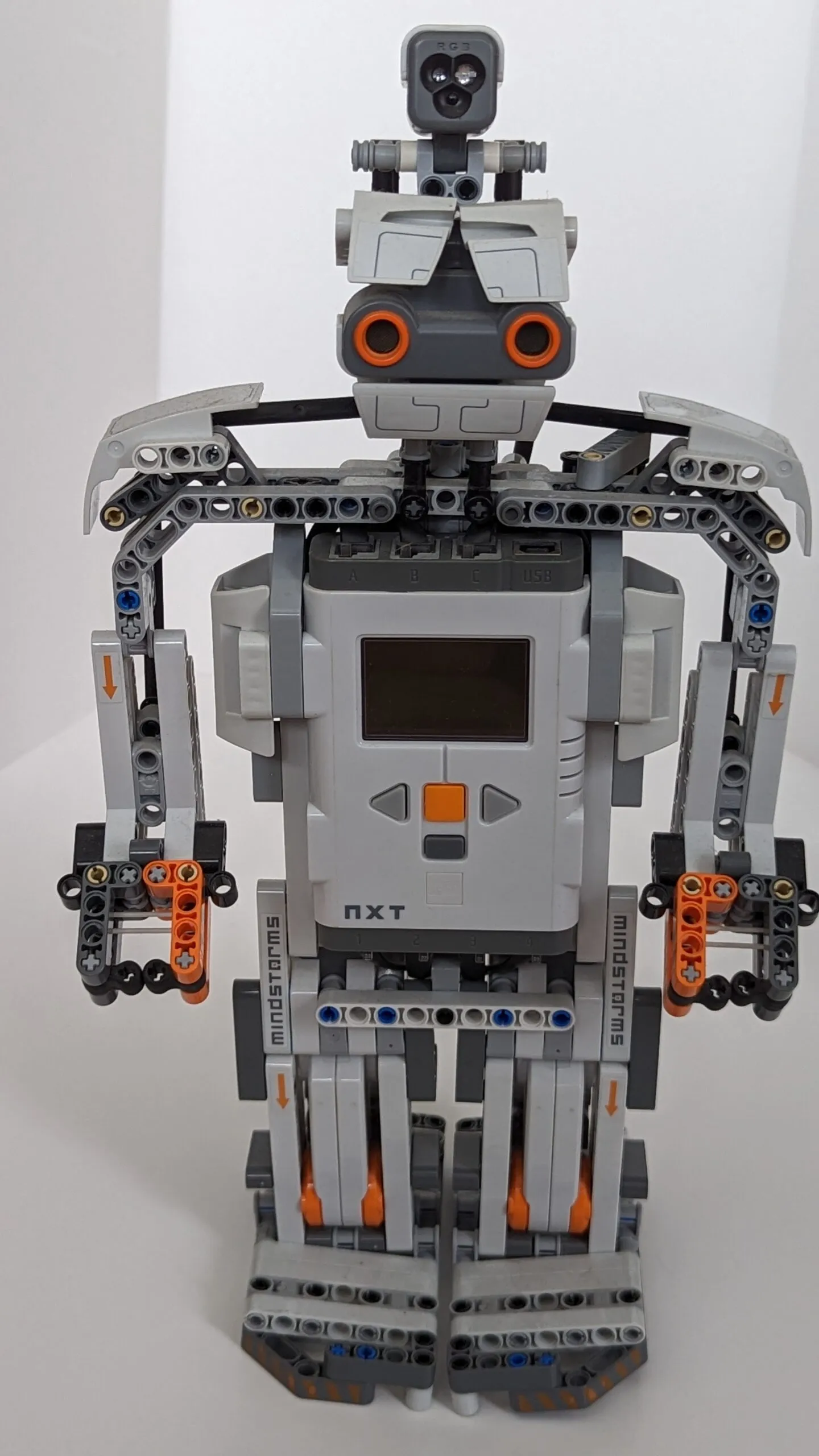Beta Rex face on: ultrasonic eyes above the NXT-brick chest, wing-blade shoulders