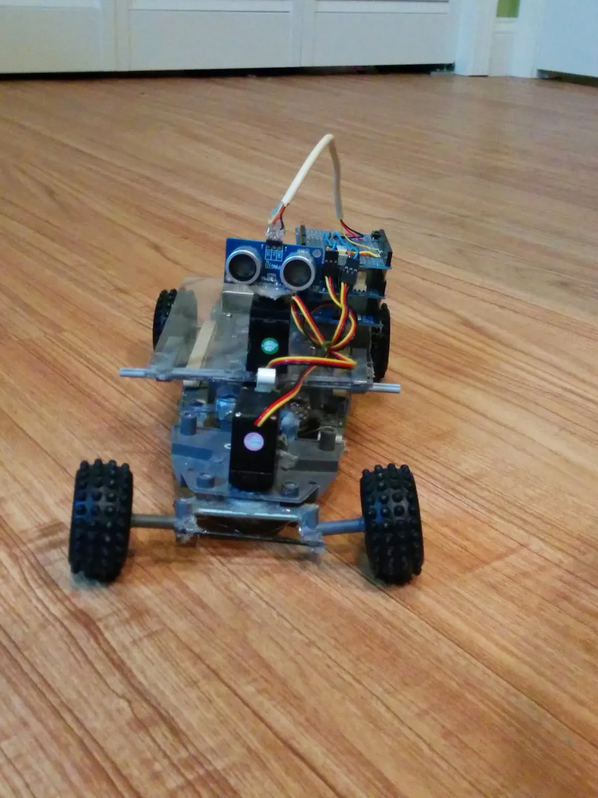 RoverBot in 2014, ultrasonic sensor staring down the camera from the clear polycarbonate deck