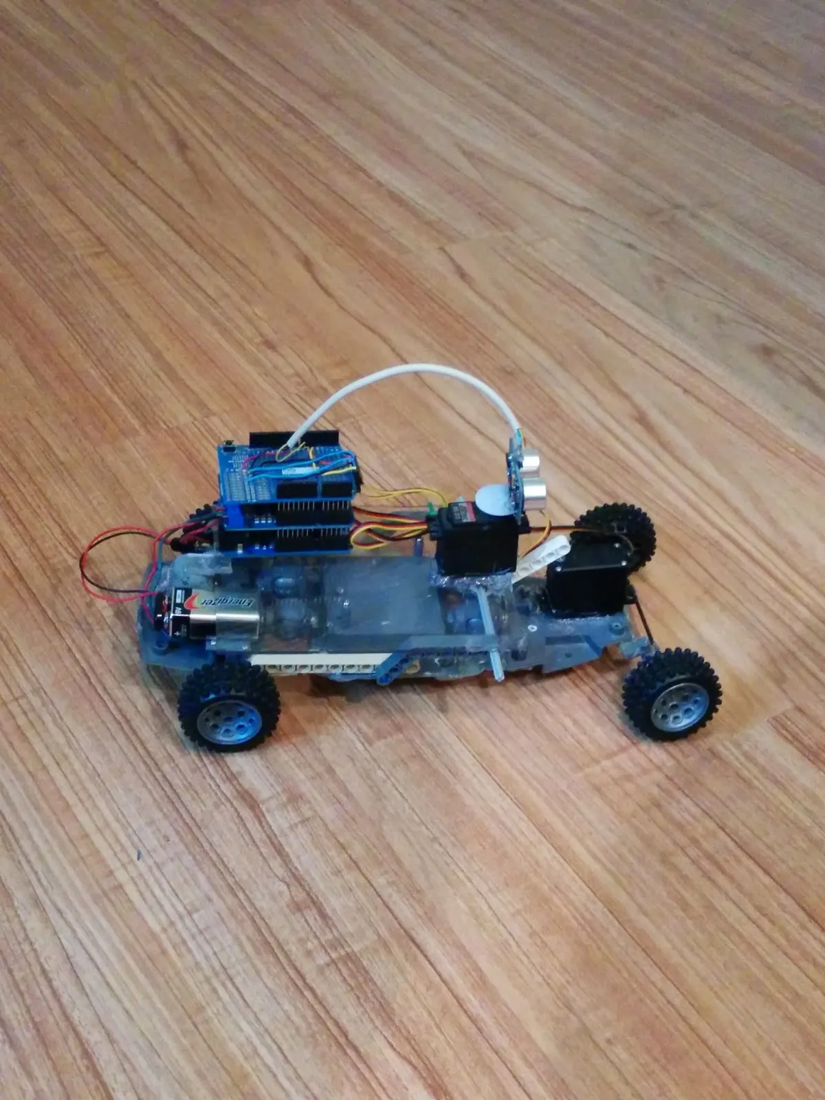 Side view of RoverBot in 2014: Arduino stack, 9V, and steering servo on the clear chassis