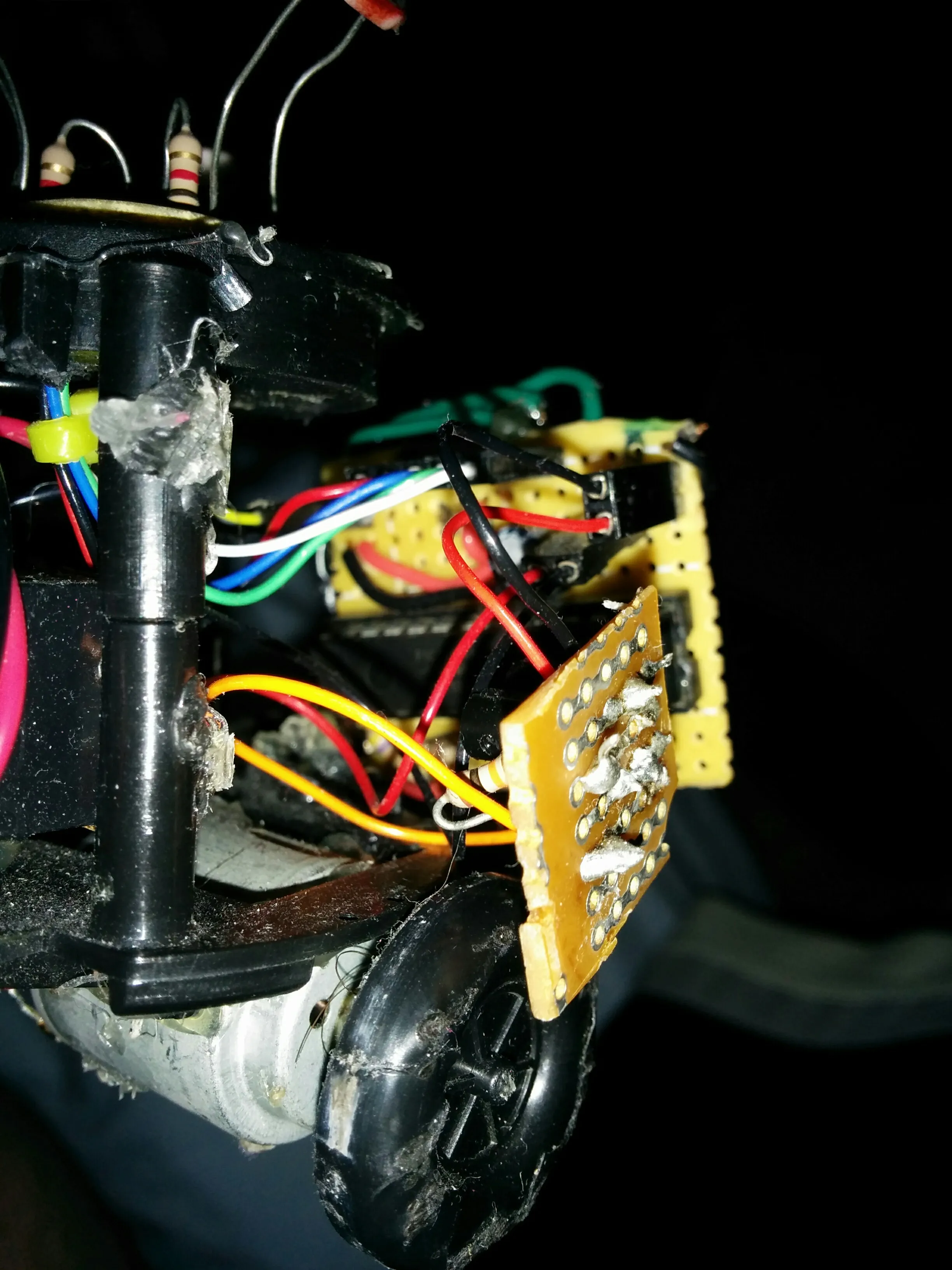 Side detail of Triclops: drive motor, wheel, and perfboards hanging off the frame
