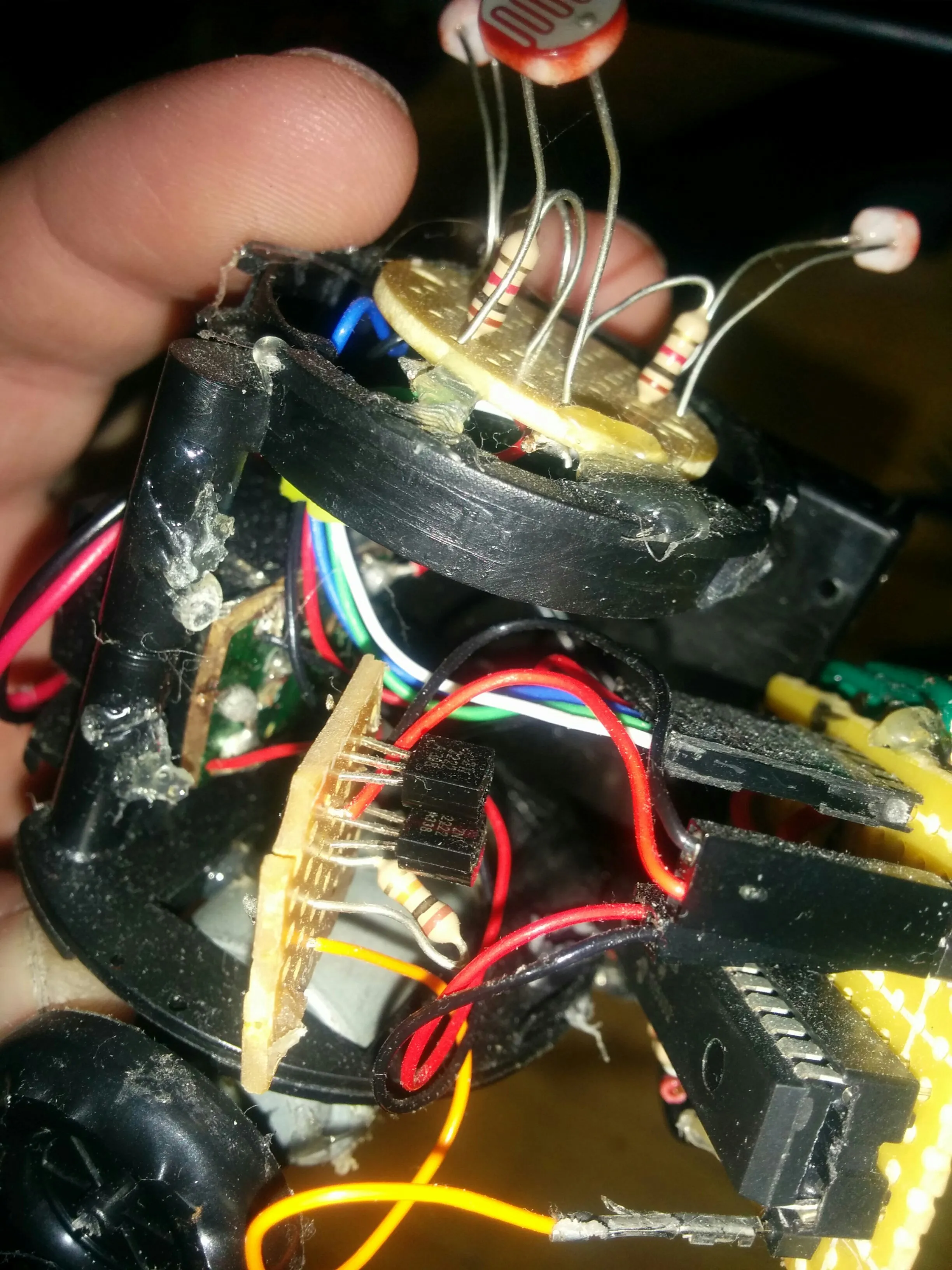 Sensor disc lifted to show the driver transistors and the hot glue holding Triclops together