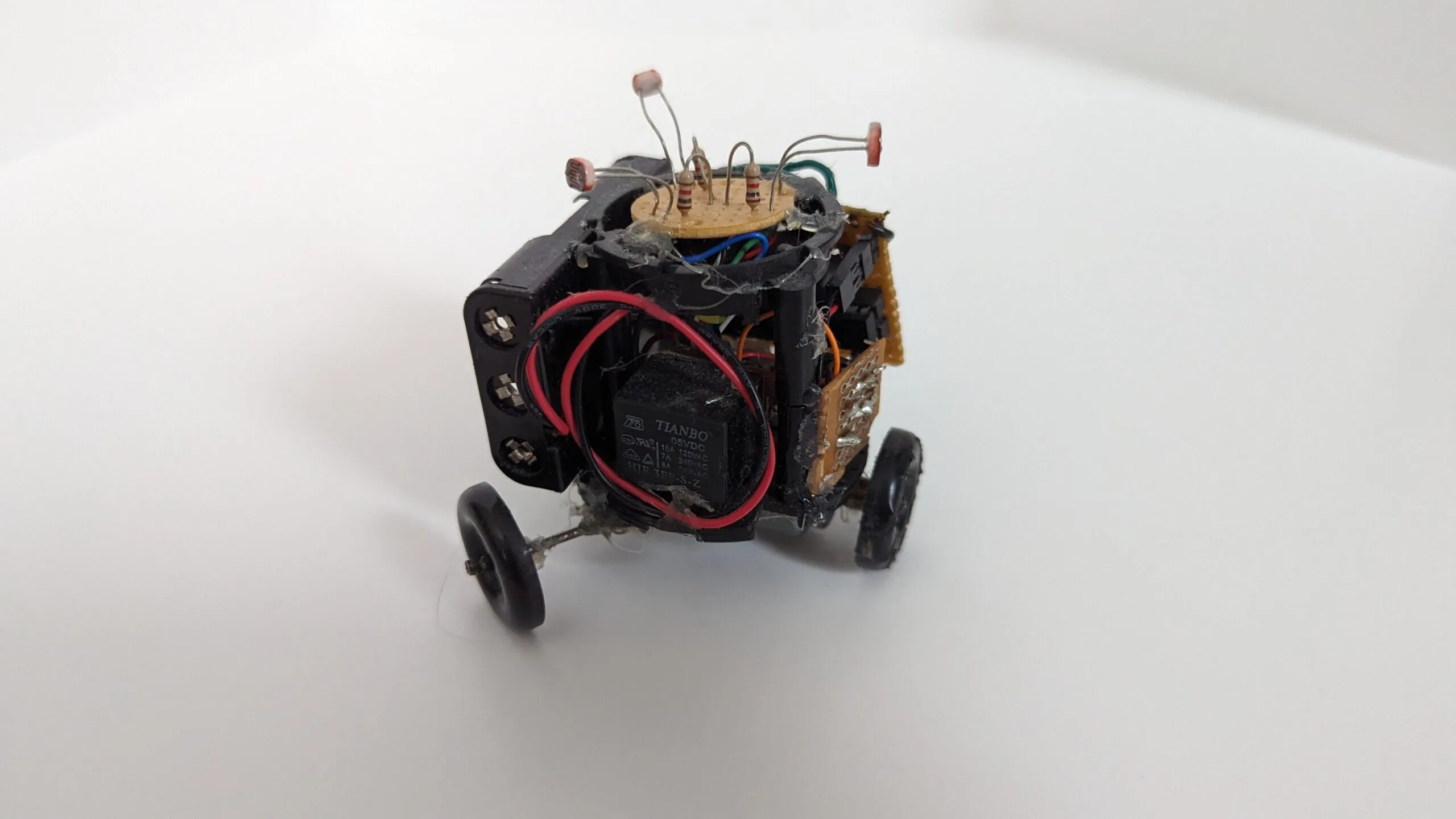 Triclops front-on, the 5 V relay riding its chest like armor