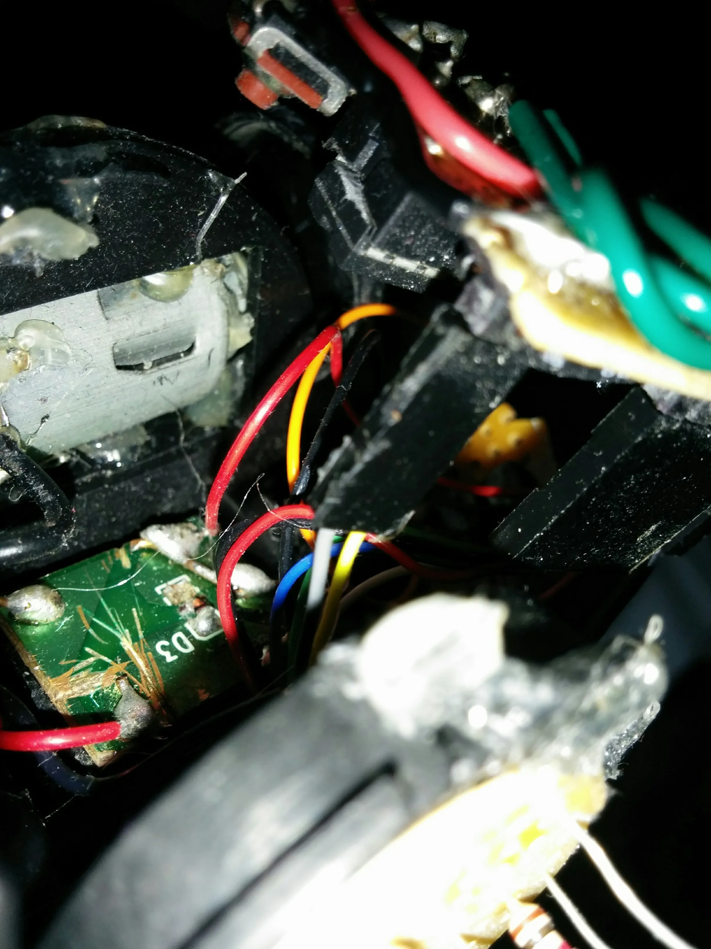 Macro into Triclops's guts: motor board, transistor pair, and every color of hookup wire
